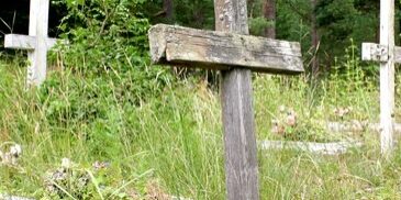 Old abandoned cemetery with wooden crosses in Pape, Latvia