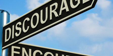 Discourage Or Encourage Directions On A Metal Signpost